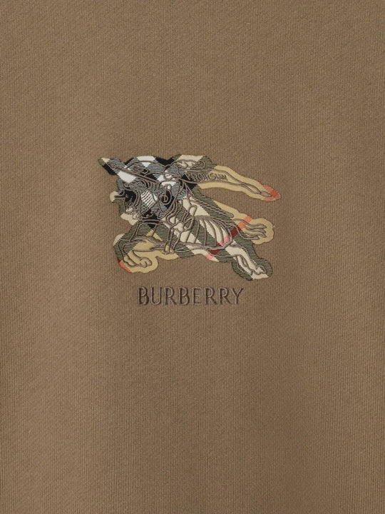 Close up of the brown shirt, showing texture of the cotton fabric