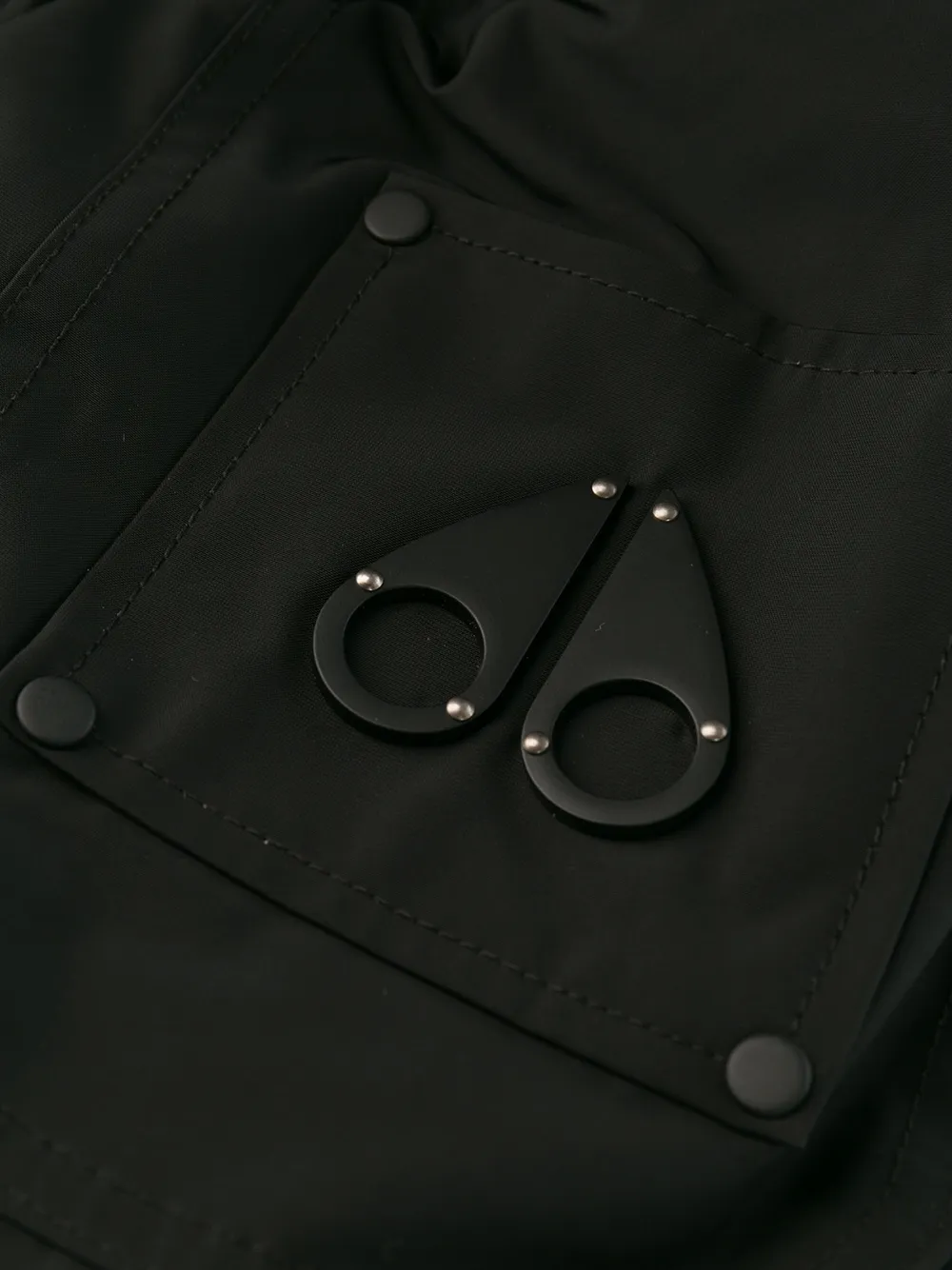 Close up of black jackets, showing texture of the nylon and polyester and feather down fabric