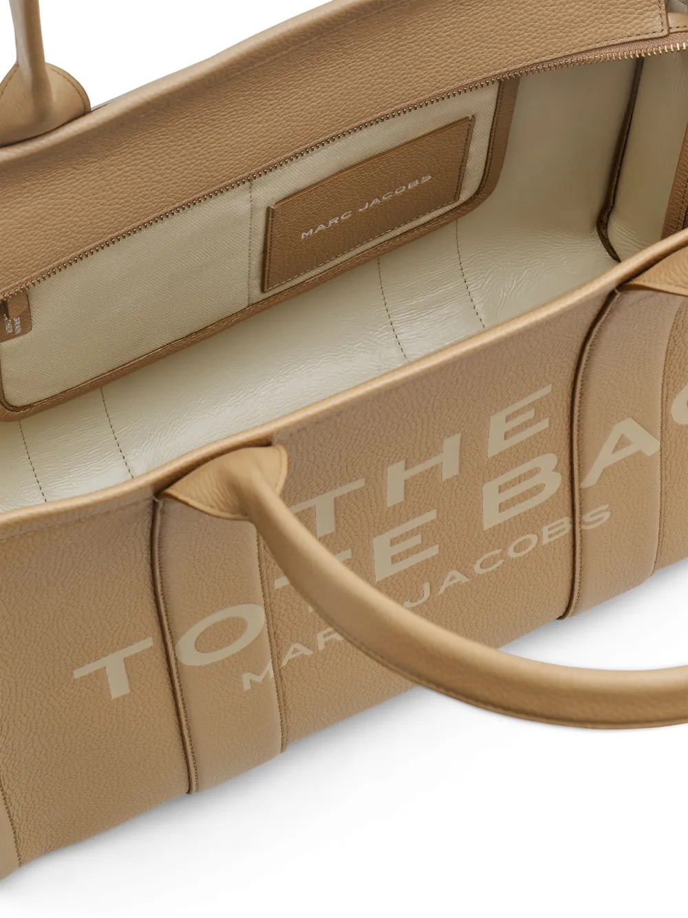 Close up of tan bags, showing texture of the cow leather fabric