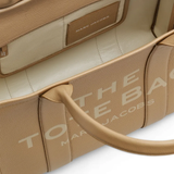 Close up of tan bags, showing texture of the cow leather fabric