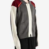 Grey knitwear worn by a person, showing the knitwear fit