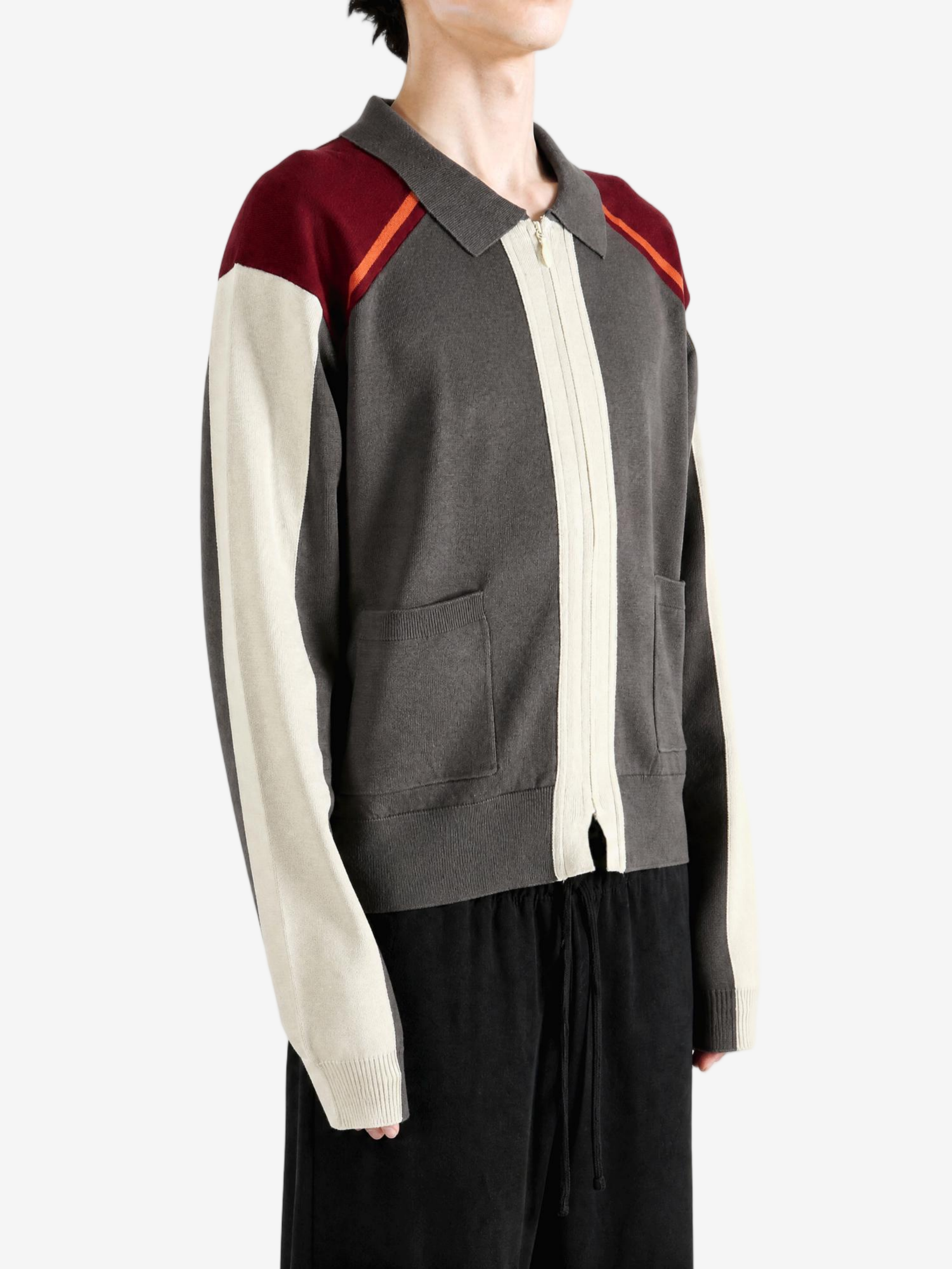 Grey knitwear worn by a person, showing the knitwear fit
