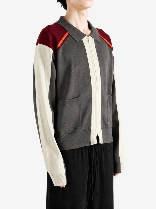 Grey knitwear worn by a person, showing the knitwear fit