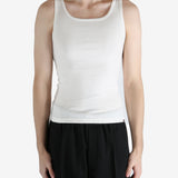 White tank worn by a person, showing the tank fit
