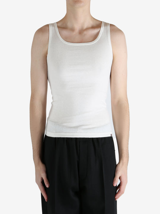 White tank worn by a person, showing the tank fit