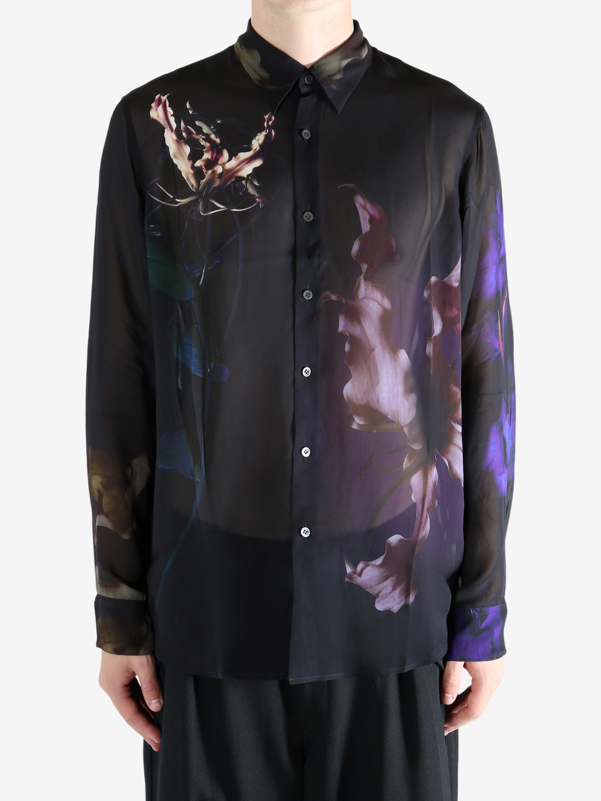 Black shirt worn by a person, showing the shirt's fit