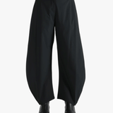 Black pants worn by a person, showing the pants' fit