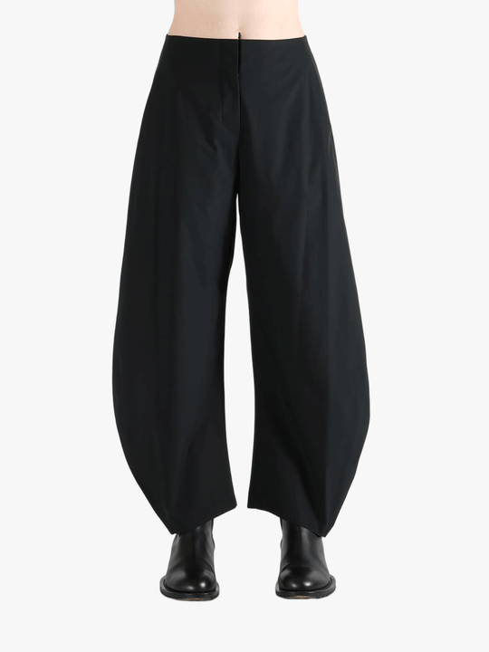 Black pants worn by a person, showing the pants' fit