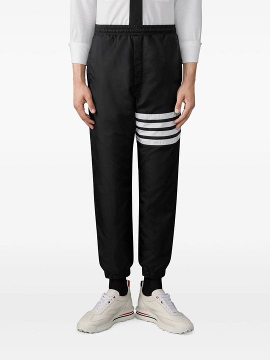 black pants worn by a person, showing the pants fit
