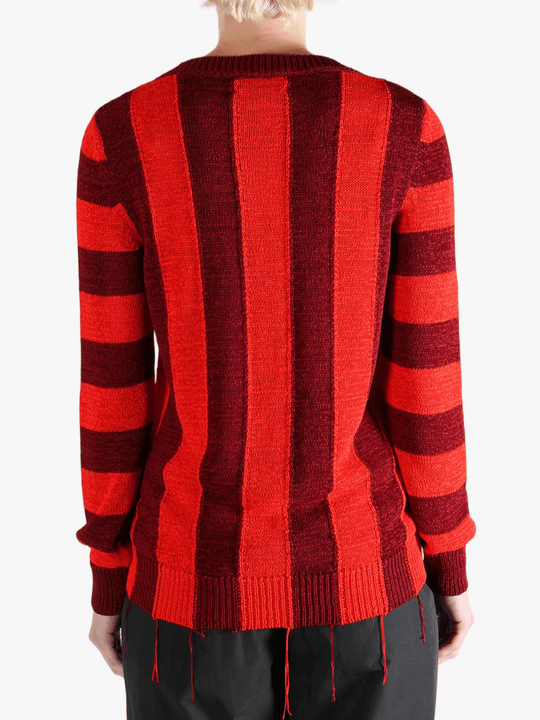 Red knitwear worn by a person, showing the knitwear fit