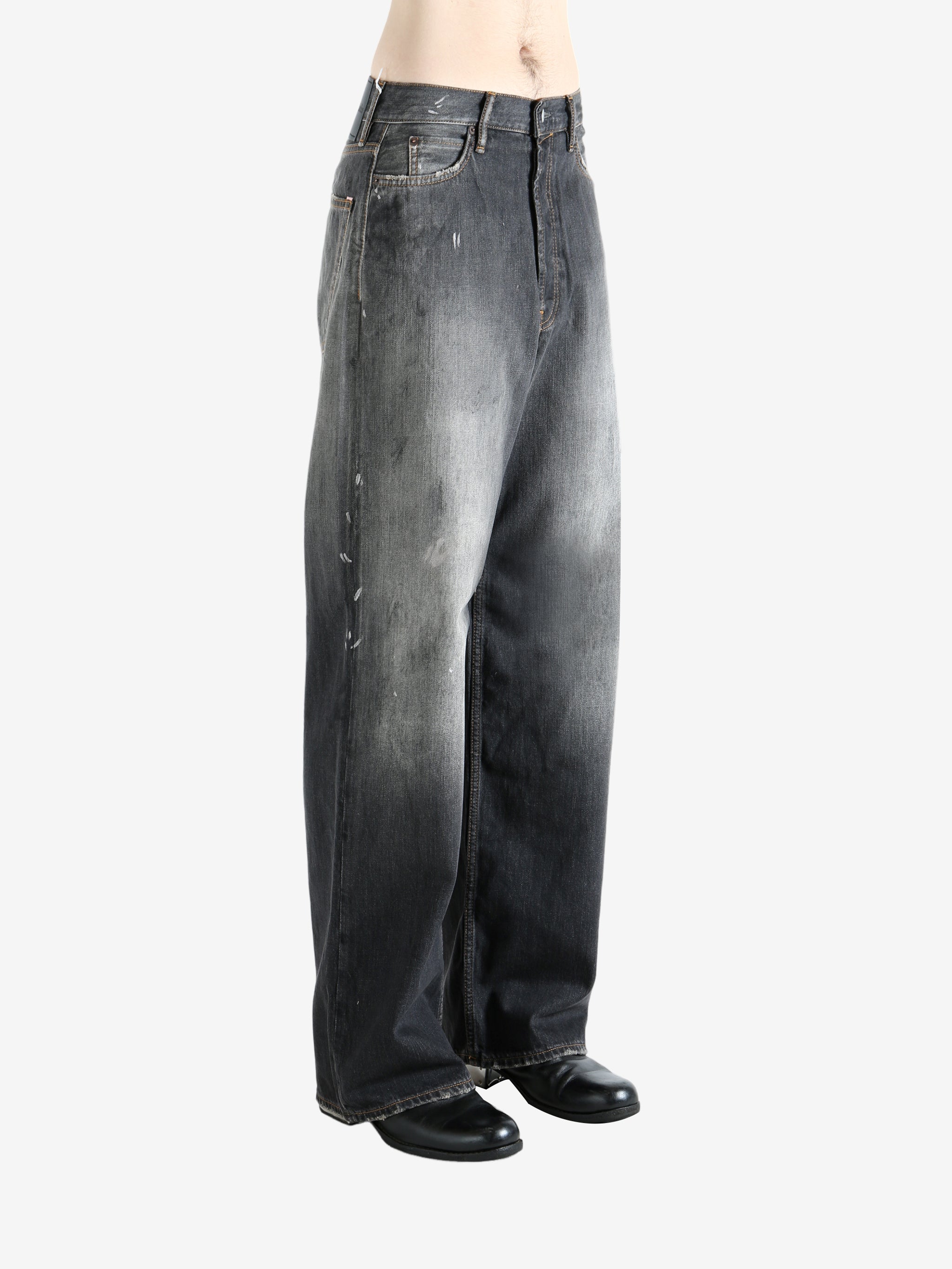 Black jeans worn by a person, showing the jeans' fit