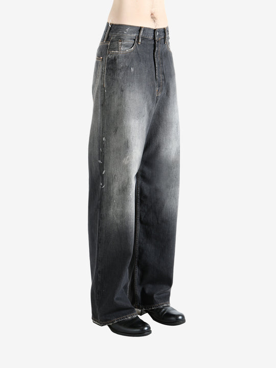 Black jeans worn by a person, showing the jeans' fit