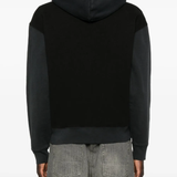 Black hoodie worn by a person, showing the hoodie fit