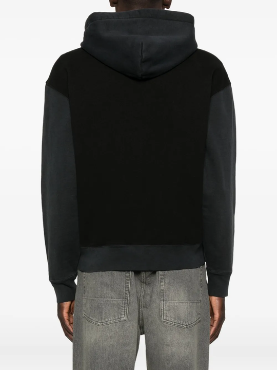 Black hoodie worn by a person, showing the hoodie fit