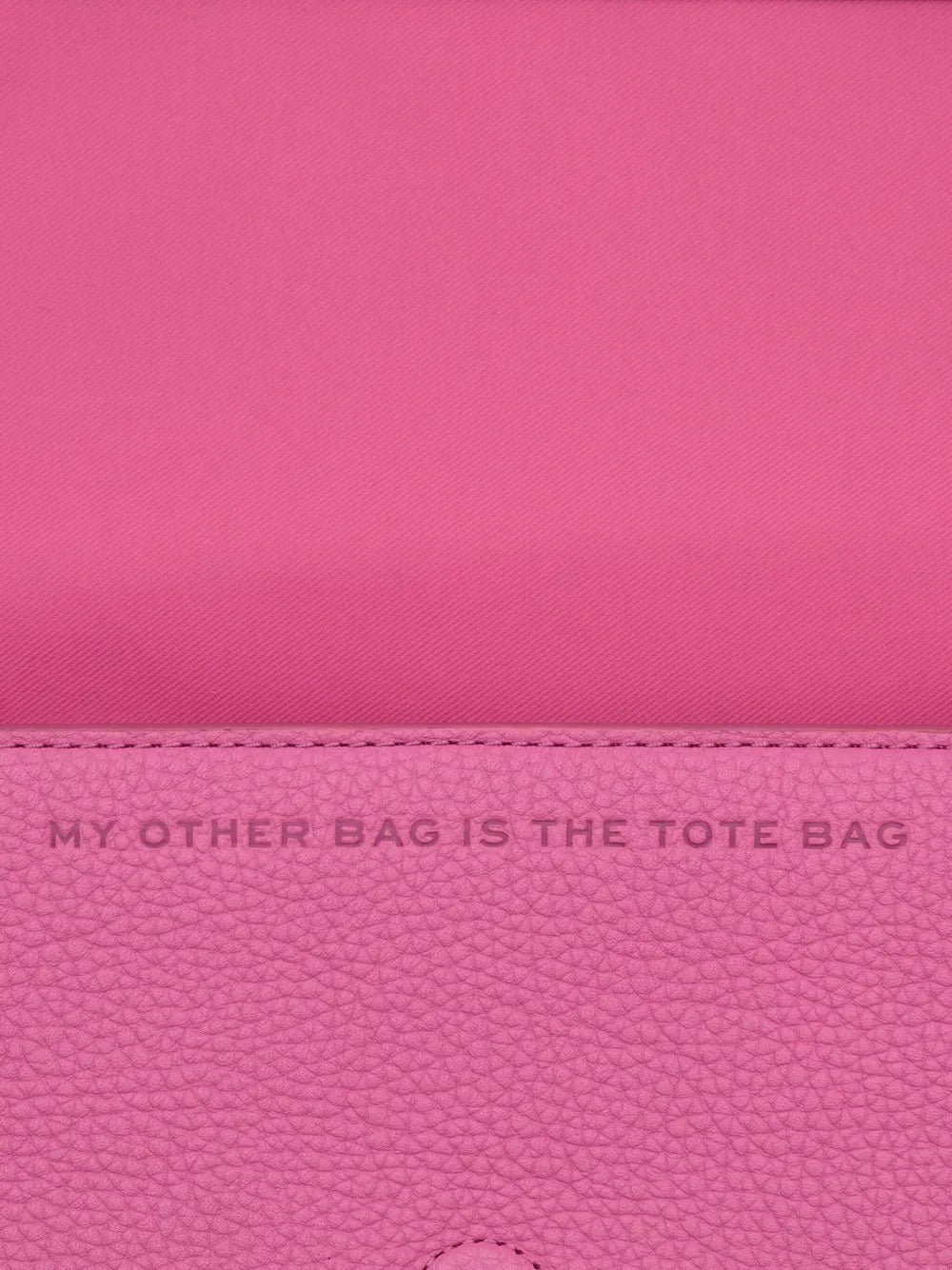 Close up of pink bag, showing texture of the leather fabric