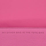 Close up of pink bag, showing texture of the leather fabric
