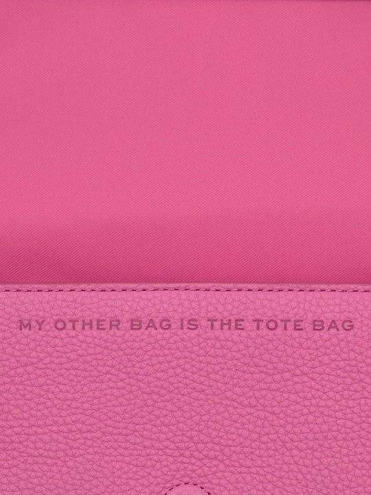 Close up of pink bag, showing texture of the leather fabric