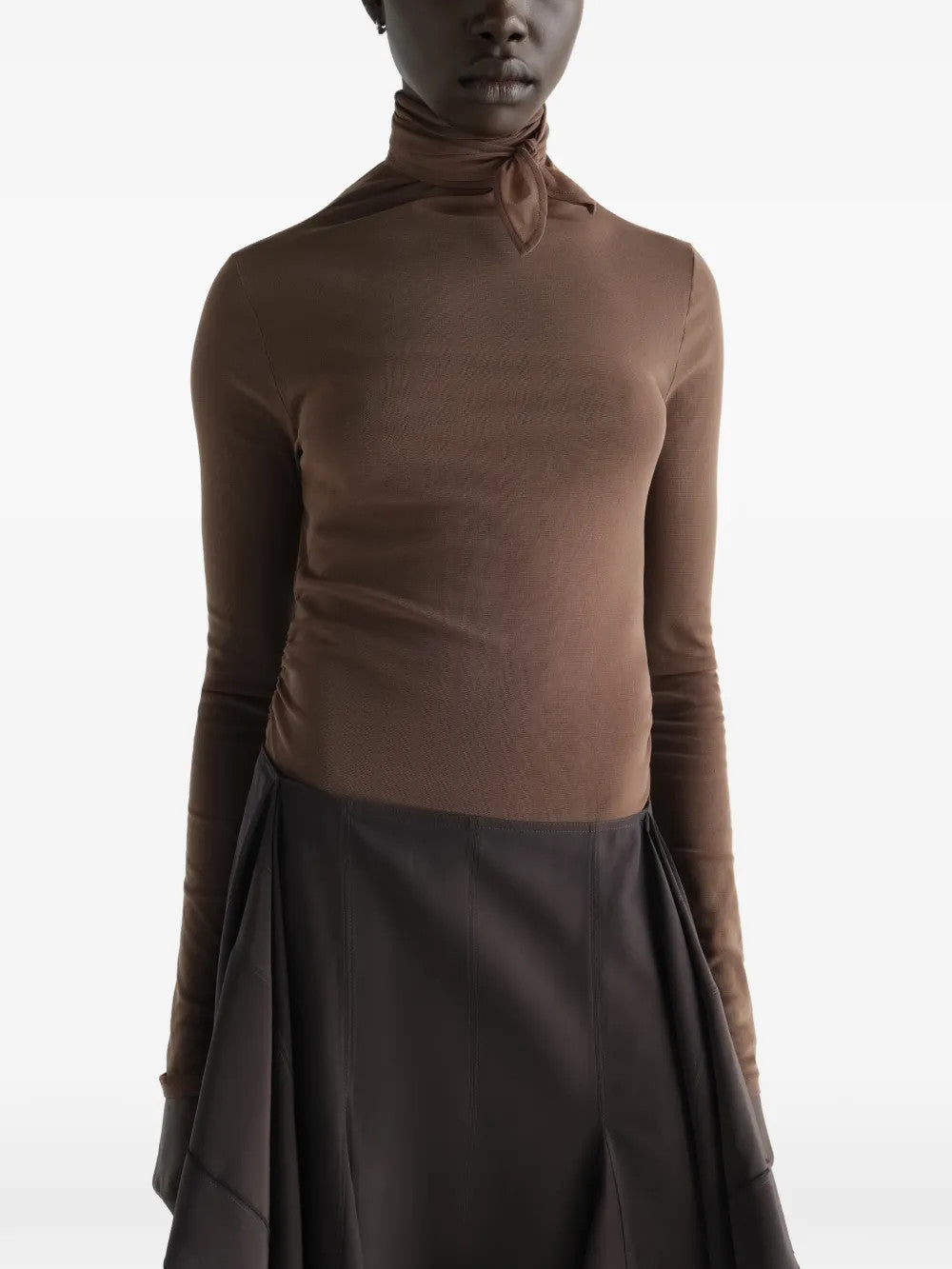 Brown top worn by a person, showing the top fit