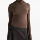 Brown top worn by a person, showing the top fit