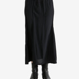 Black skirts worn by a person, showing the skirts fit