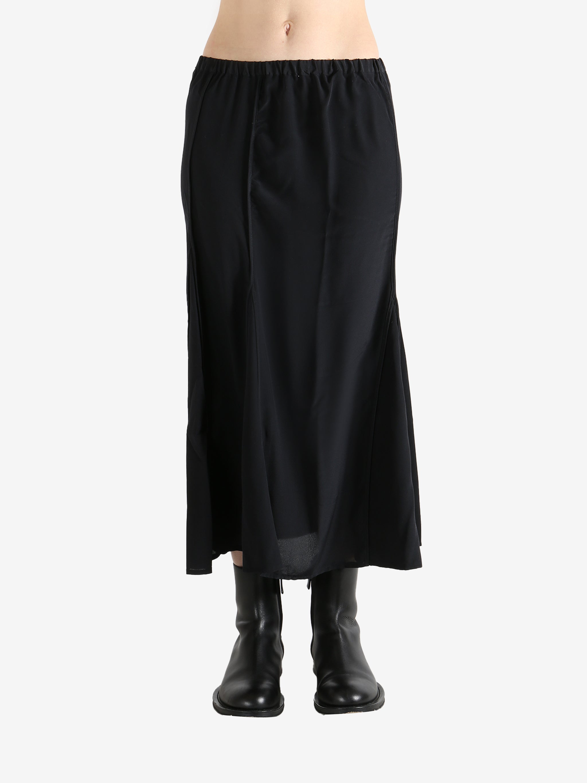 Black skirts worn by a person, showing the skirts fit