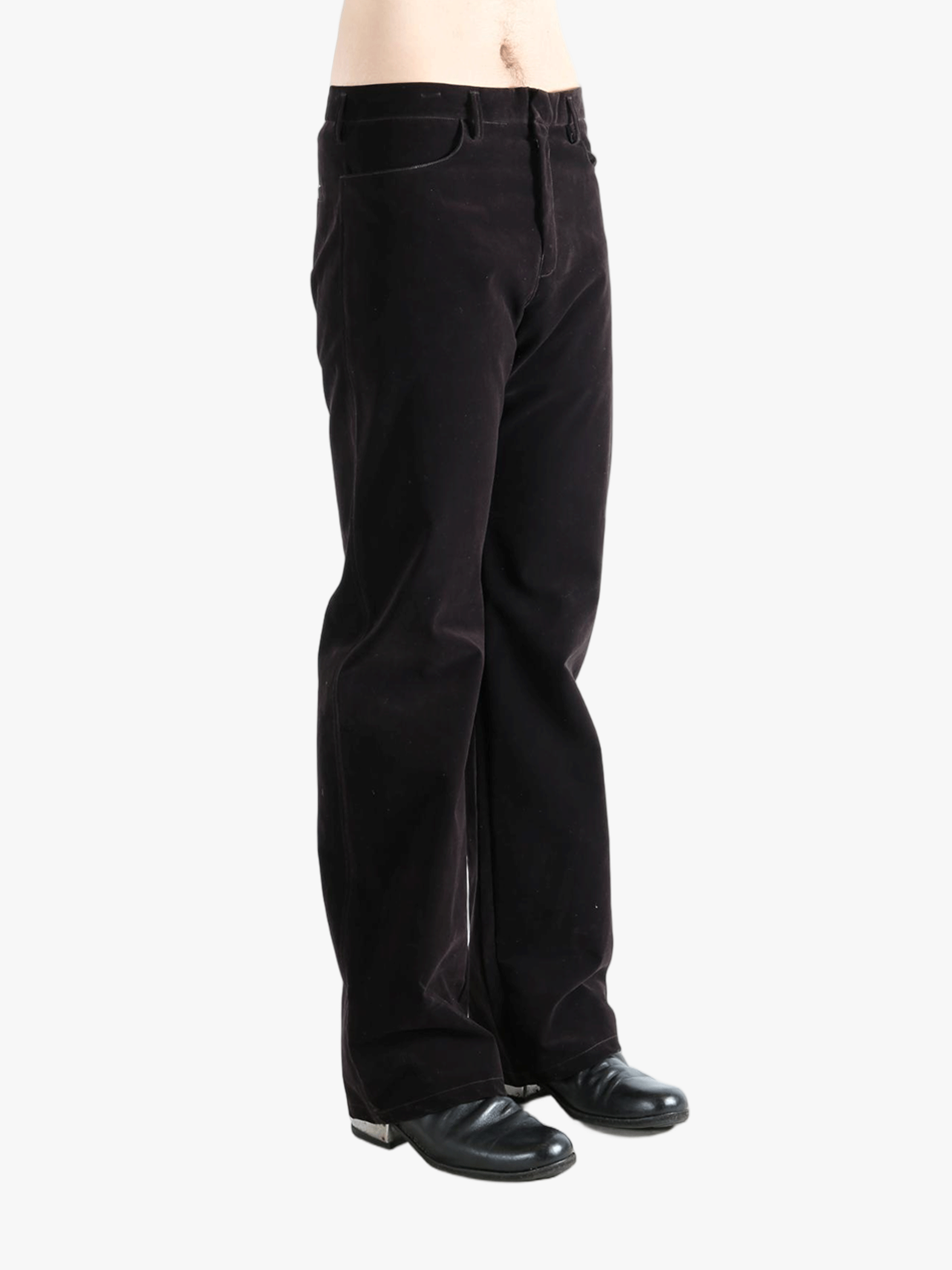 Black pants worn by a person, showing the pants  fit