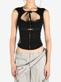 Black tops worn by a person, showing the tops's fit