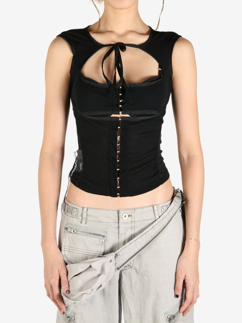 Black tops worn by a person, showing the tops's fit