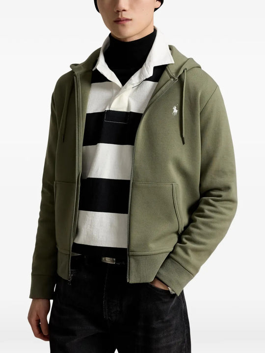 Green hoodie worn by a person, showing the hoodie fit
