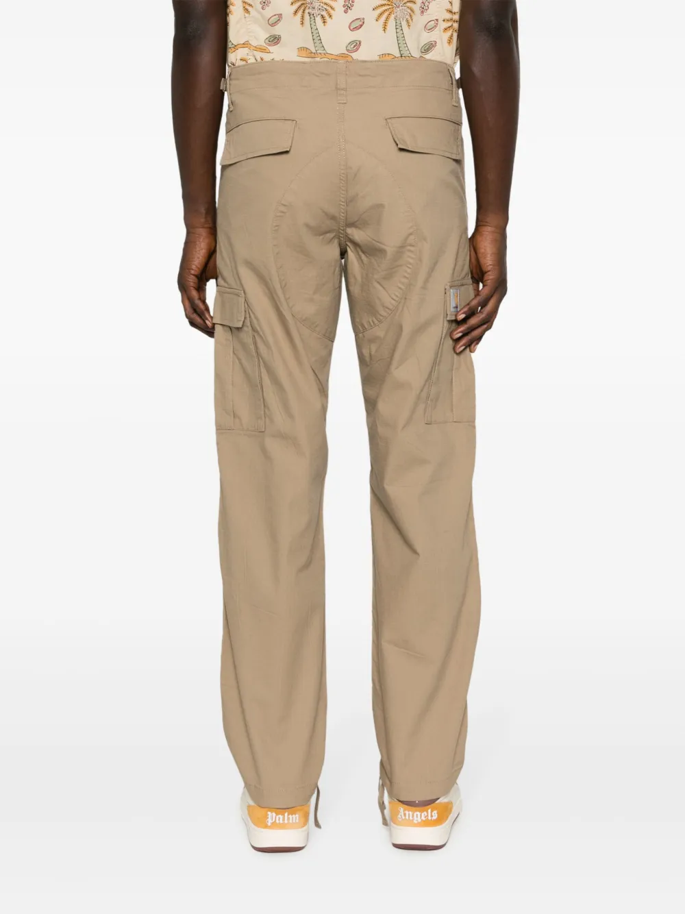 Tan pants worn by a person, showing the pants’ fit
