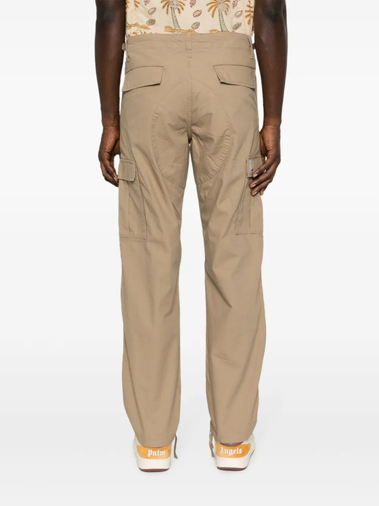 Tan pants worn by a person, showing the pants’ fit
