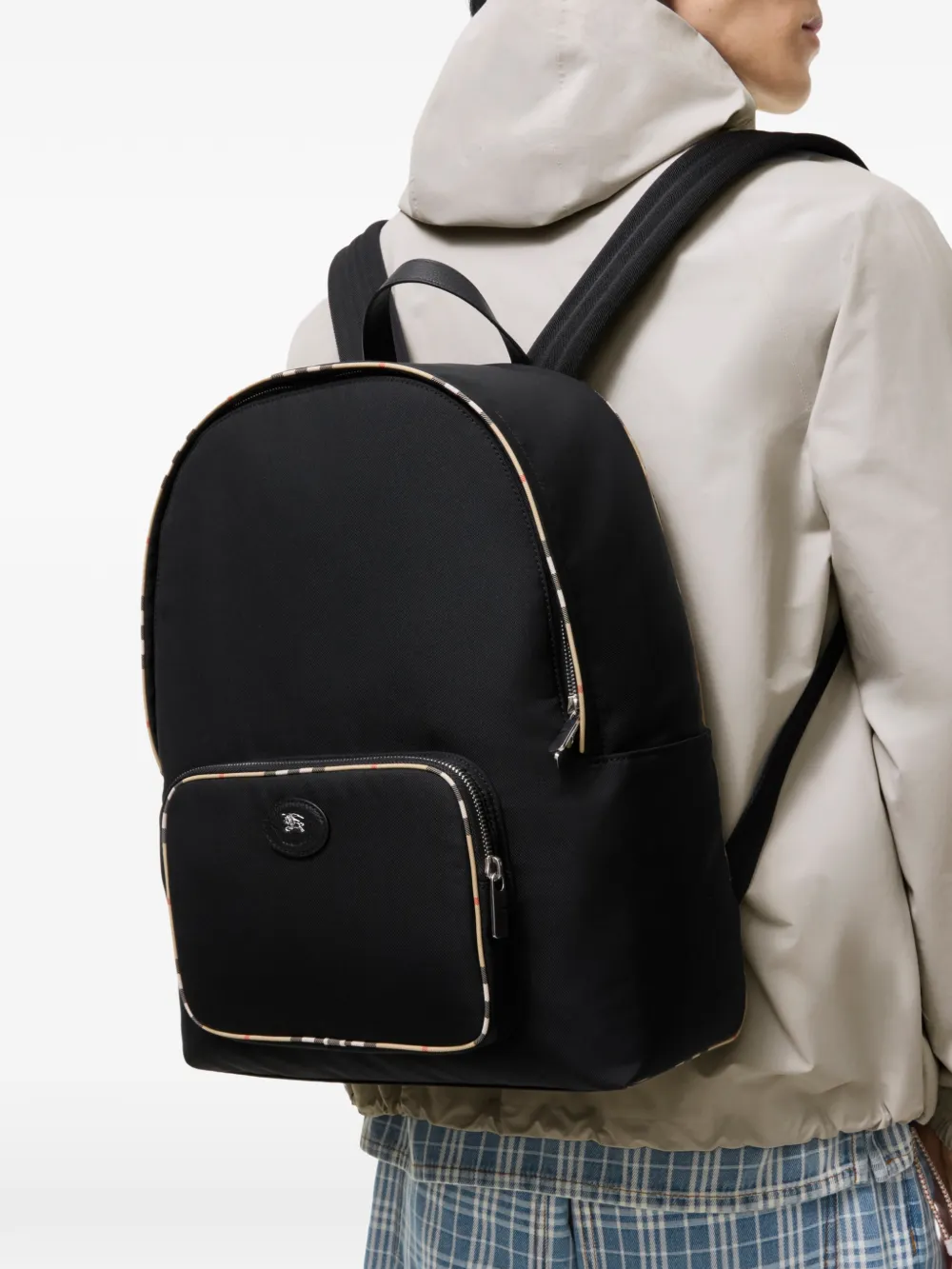Black bag worn by a person, showing the black bag's fit
