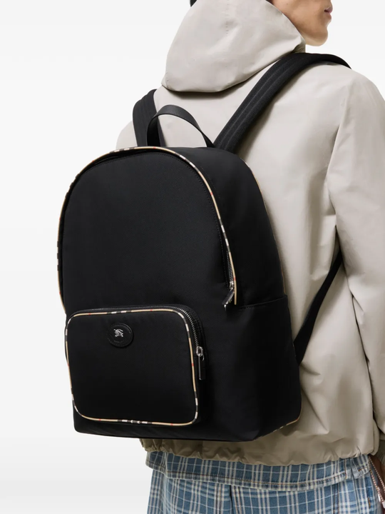 Black bag worn by a person, showing the black bag's fit