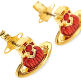 Close up of Yellow earrings, showing texture of the brass fabric