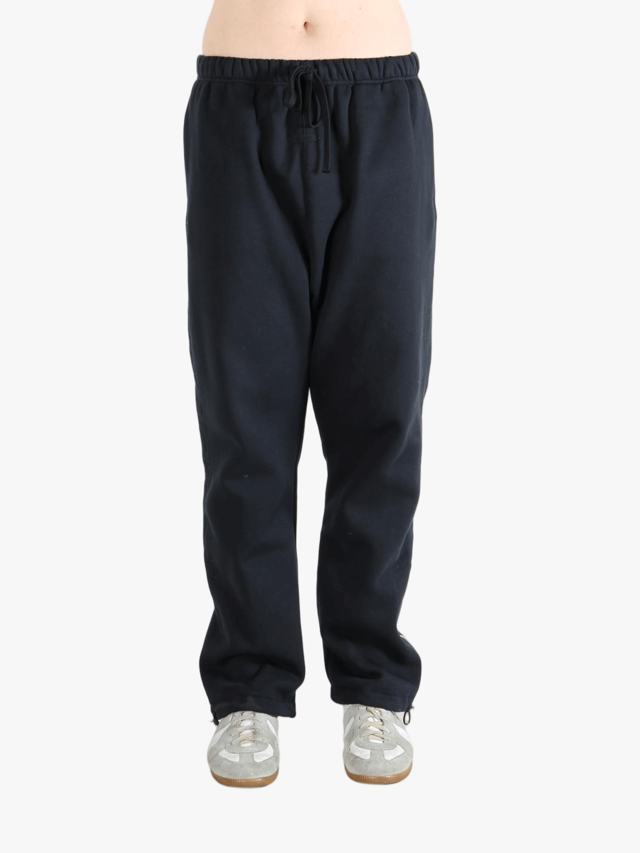 Black pants worn by a person, showing the pants fit