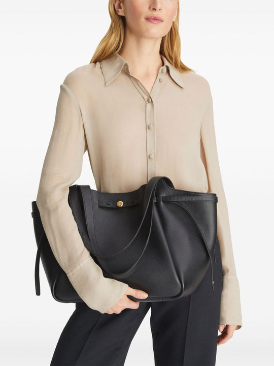 Black bags worn by a person, showing the bags fit