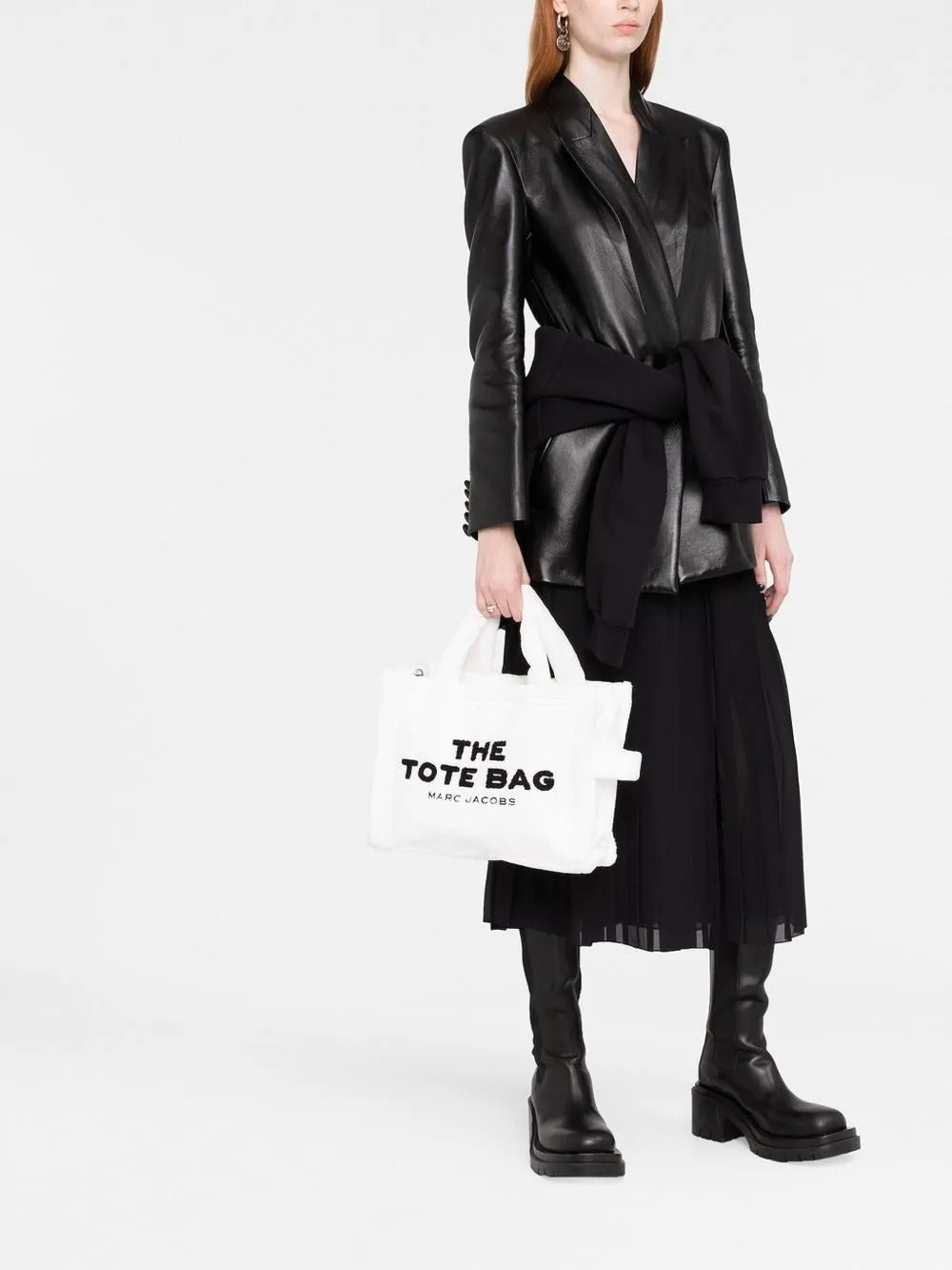 White bag carried by a person, showing the bag's fit