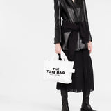 White bag carried by a person, showing the bag's fit