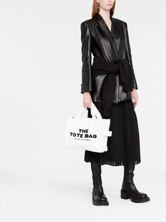 White bag carried by a person, showing the bag's fit