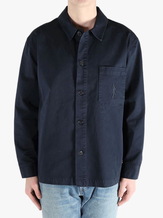 Navy shirts worn by a person, showing the shirts fit