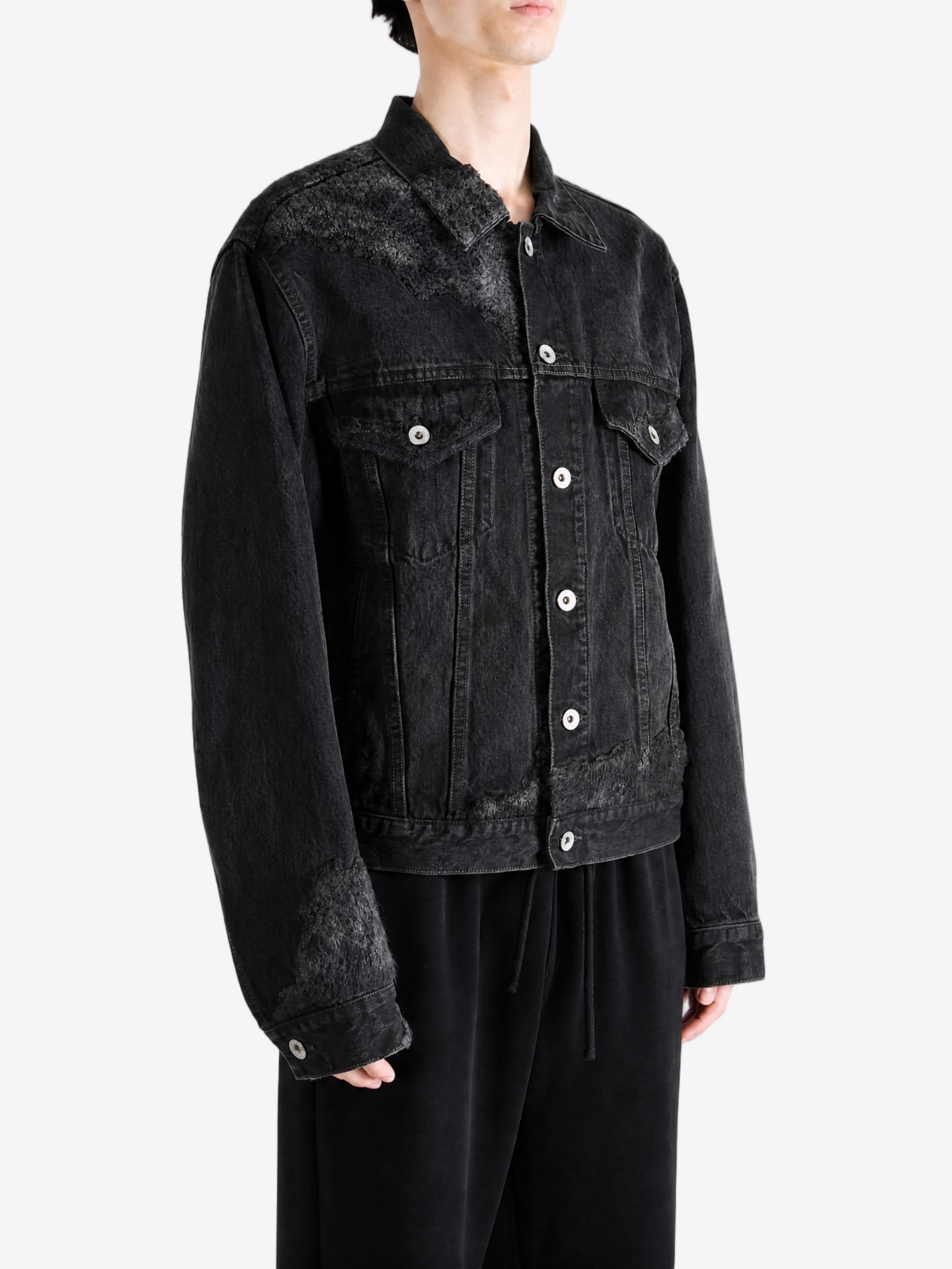 Black jacket worn by a person, showing the jacket fit