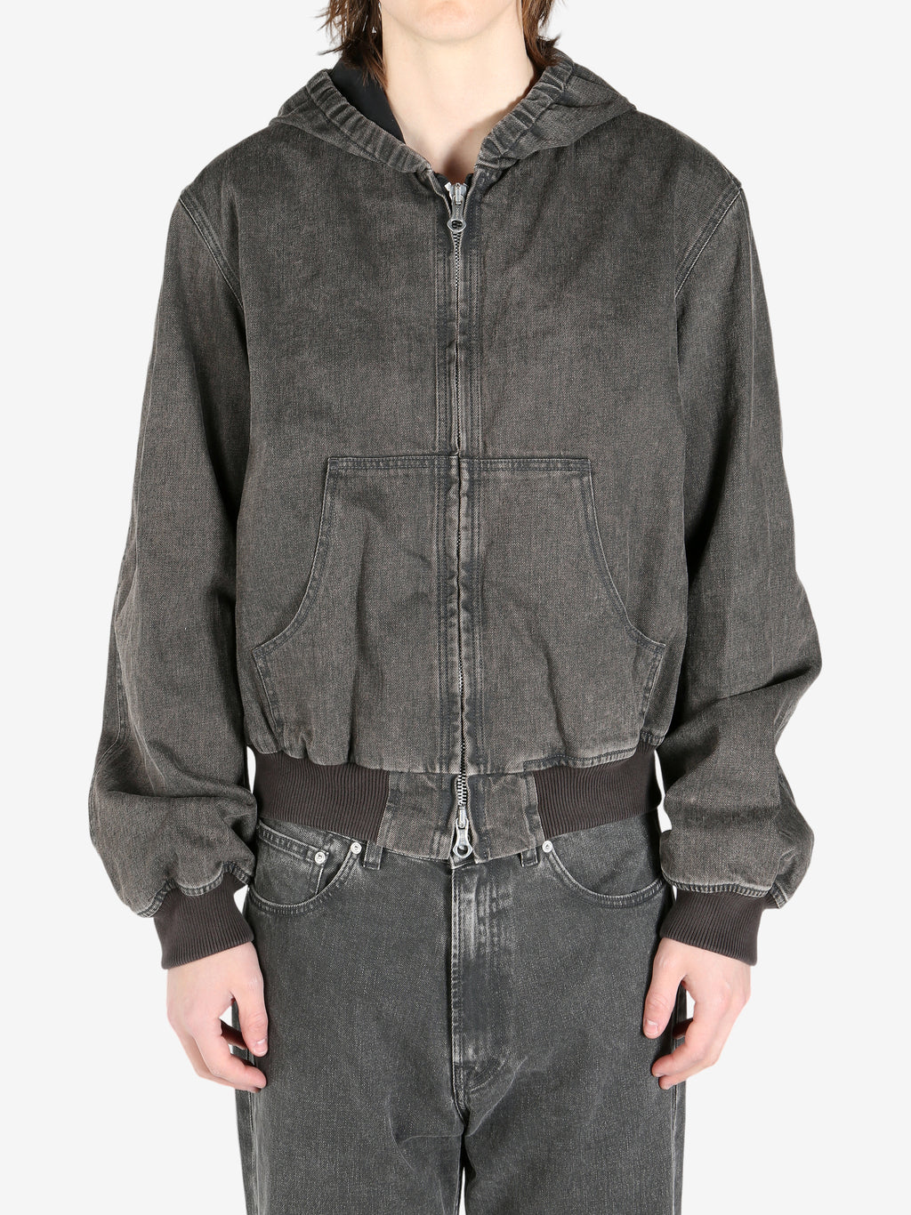 Black coat worn by a person, showing the coat fit