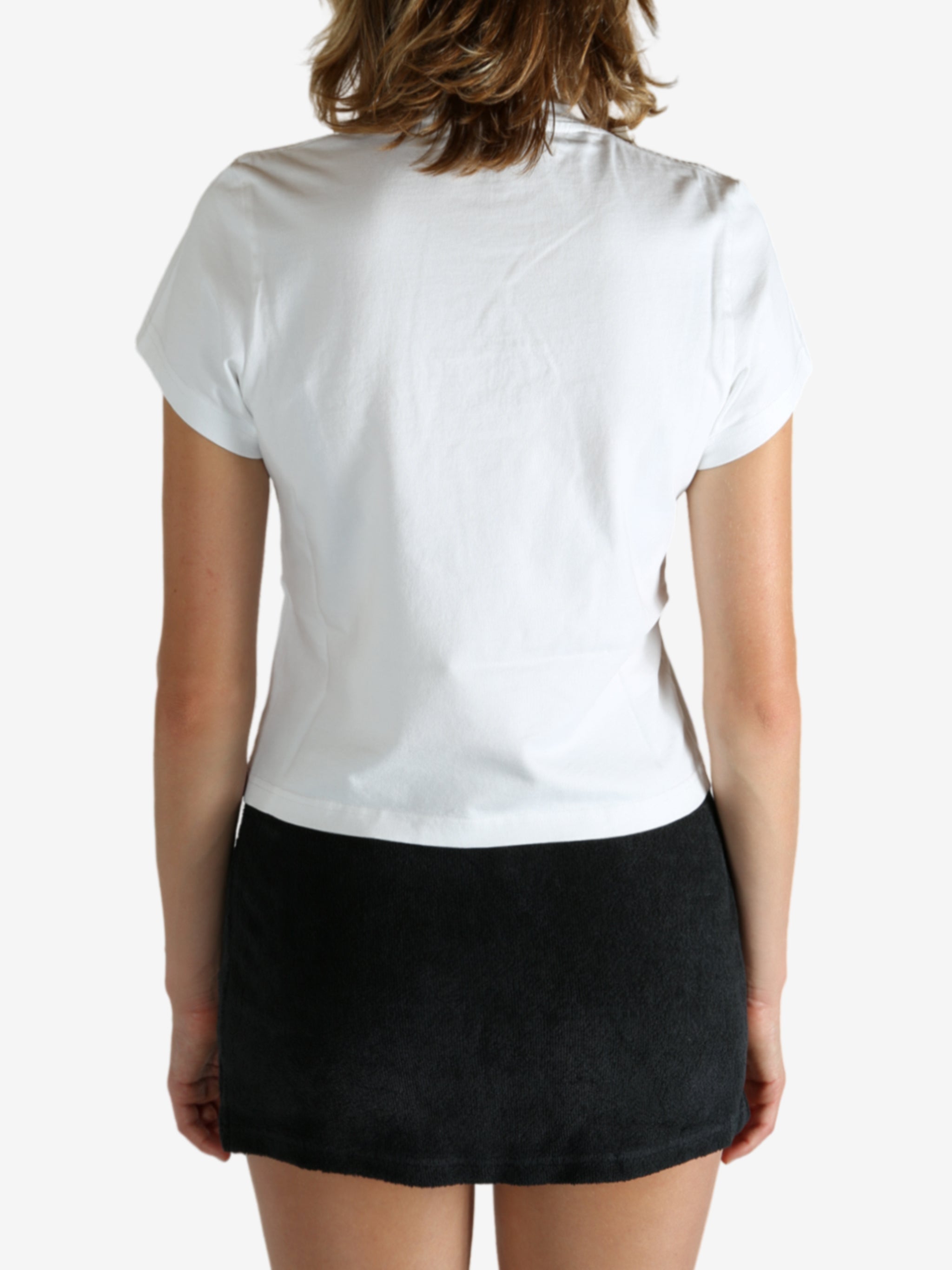 White t-shirt worn by a person, showing the shirt's fit