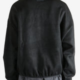 Black sweatshirt worn by a person, showing the sweatshirt's fit