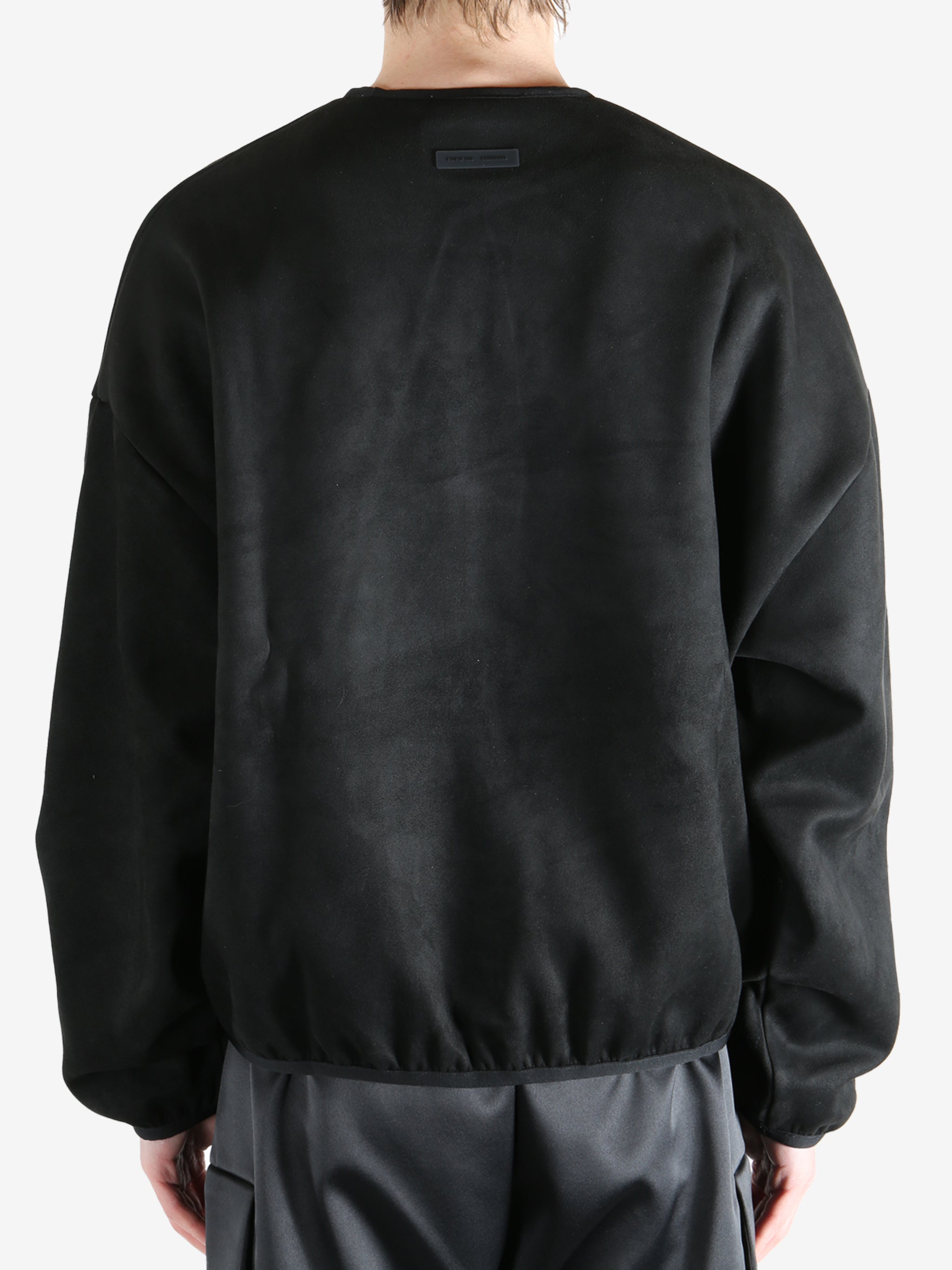 Black sweatshirt worn by a person, showing the sweatshirt's fit