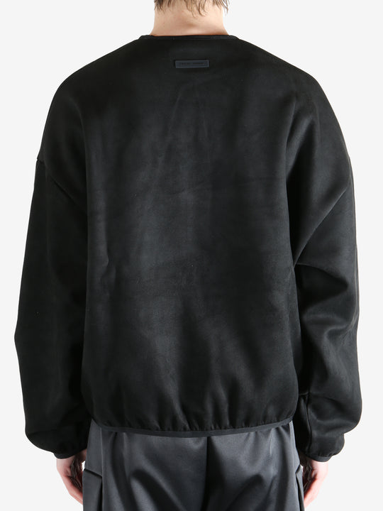 Black sweatshirt worn by a person, showing the sweatshirt's fit