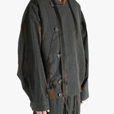 Grey jacket worn by person, showing the jacket's fit