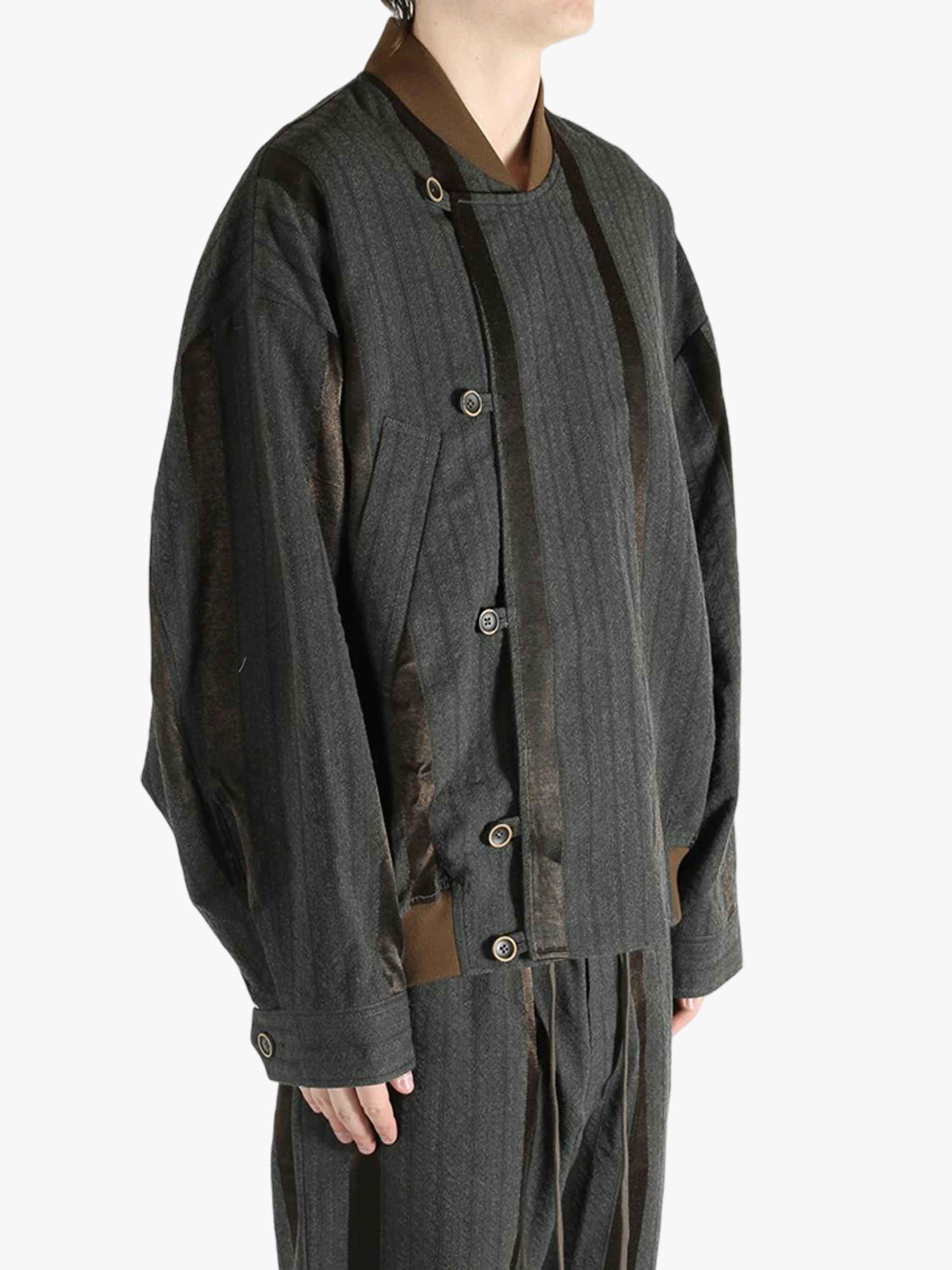 Grey jacket worn by person, showing the jacket's fit