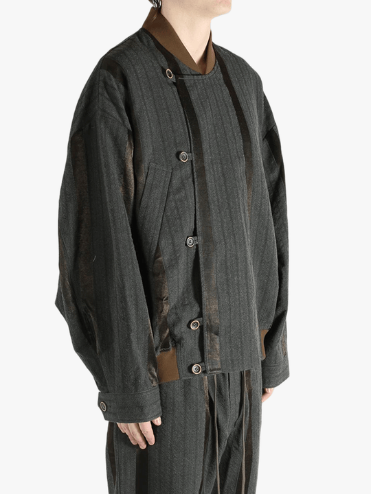 Grey jacket worn by person, showing the jacket's fit