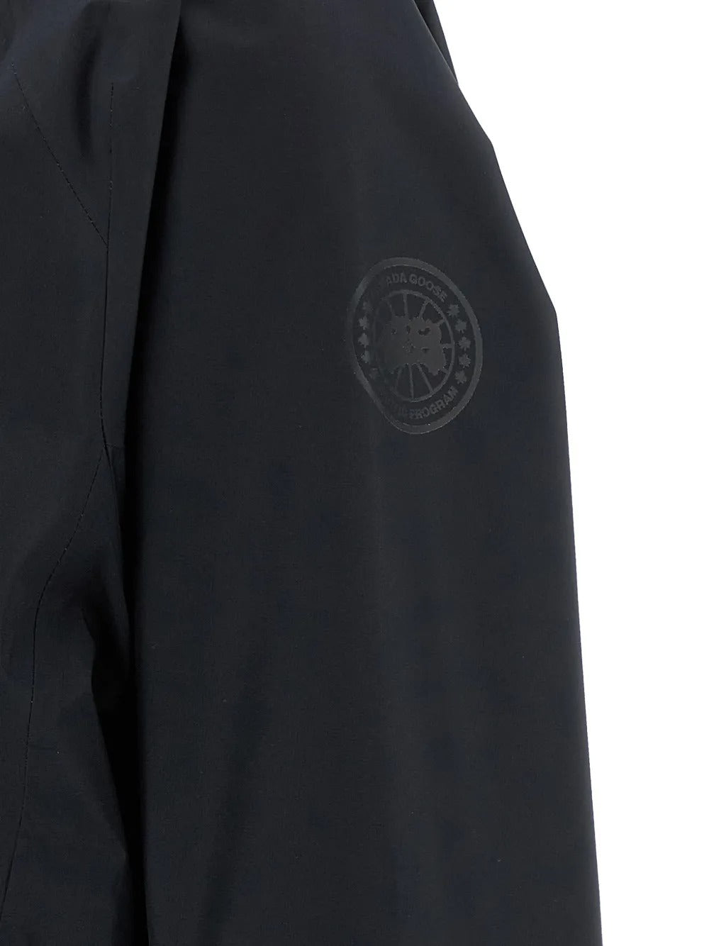Close up of the black jacket, showing texture of the polyester fabric